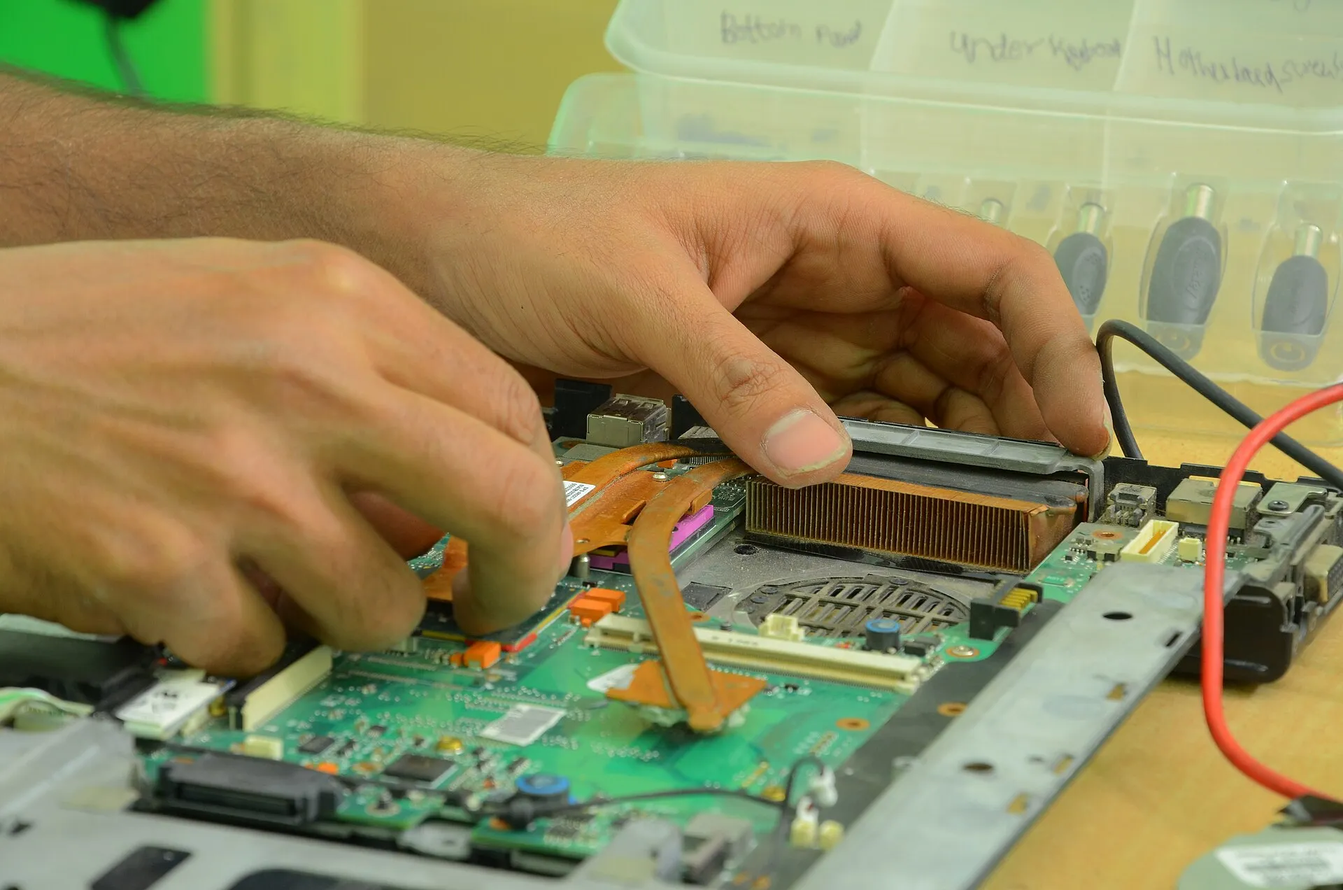 Un ordinateur portable ouvert sur un établi d'atelier, en cours de réparation